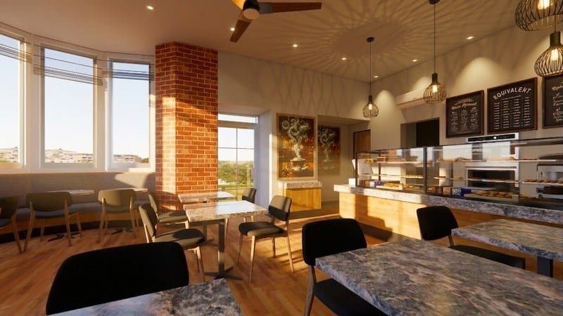Bakery seating area beside large windows with pendant lighting