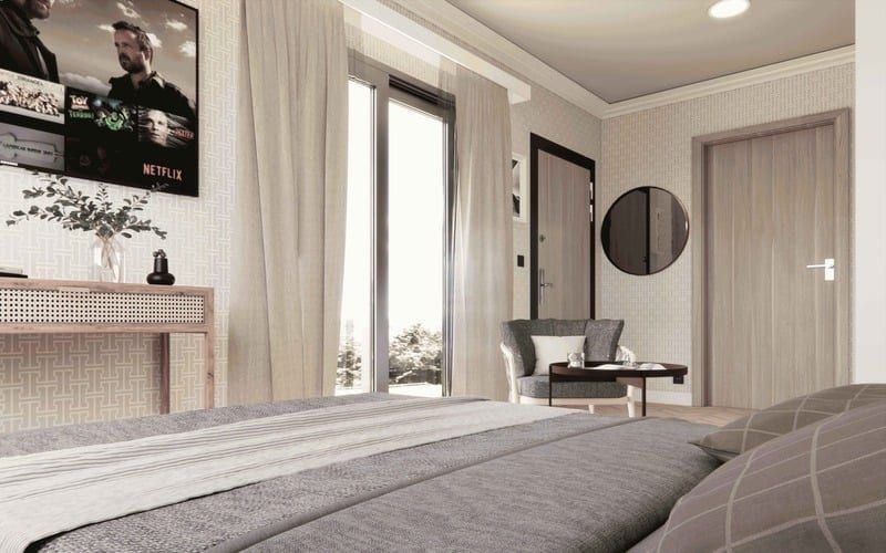 Bed facing the entry with wall-mounted television